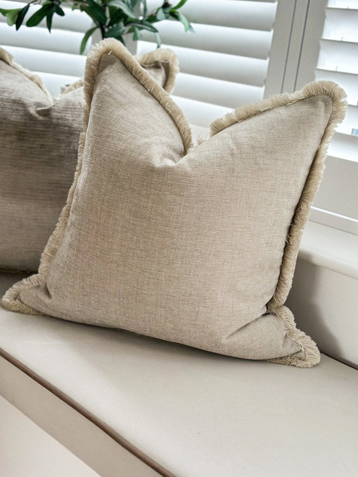 Luxury fringed pillow in natural.
