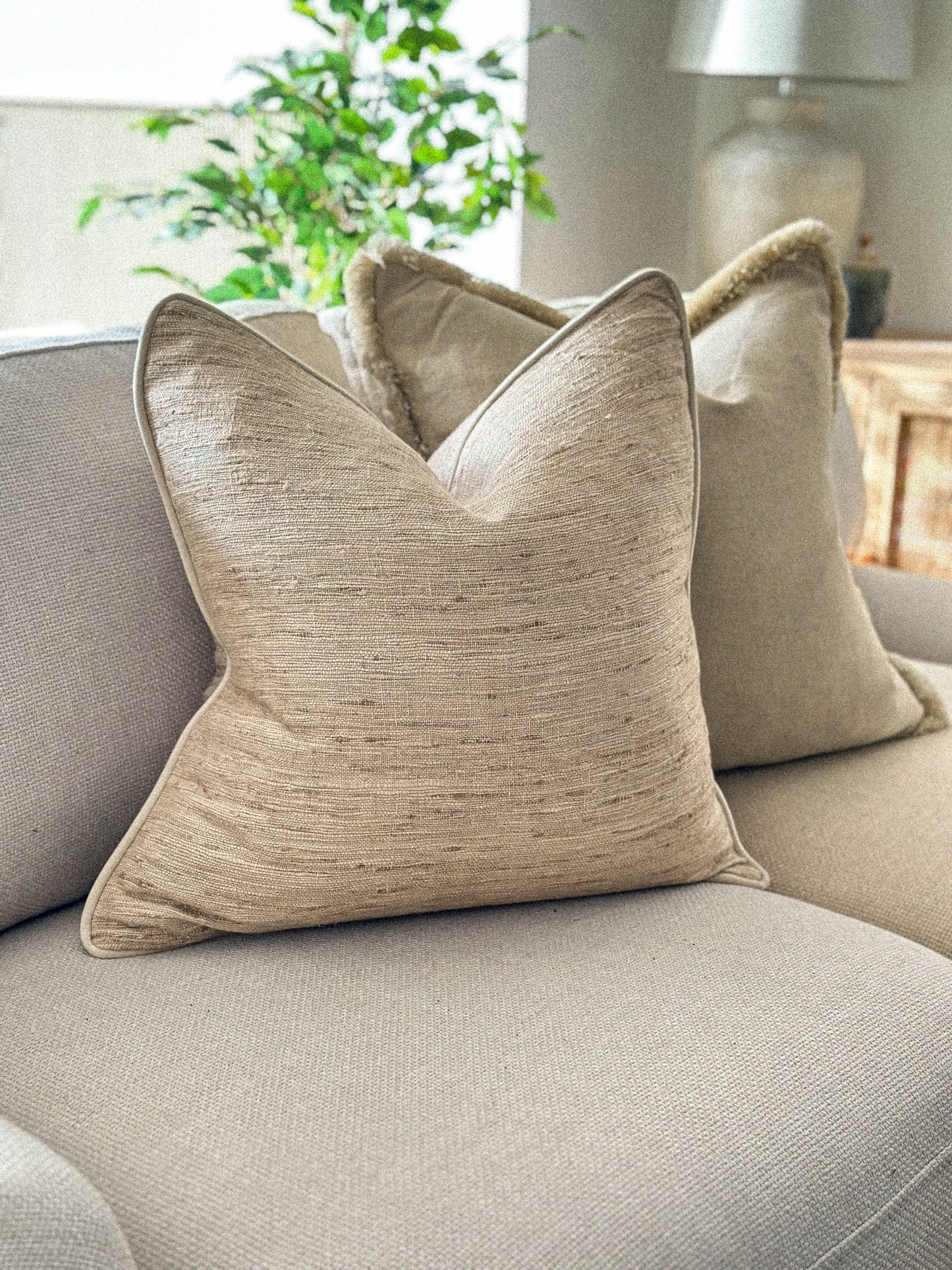 Textured slubby linen cushion in a cream beige oatmeal tone.