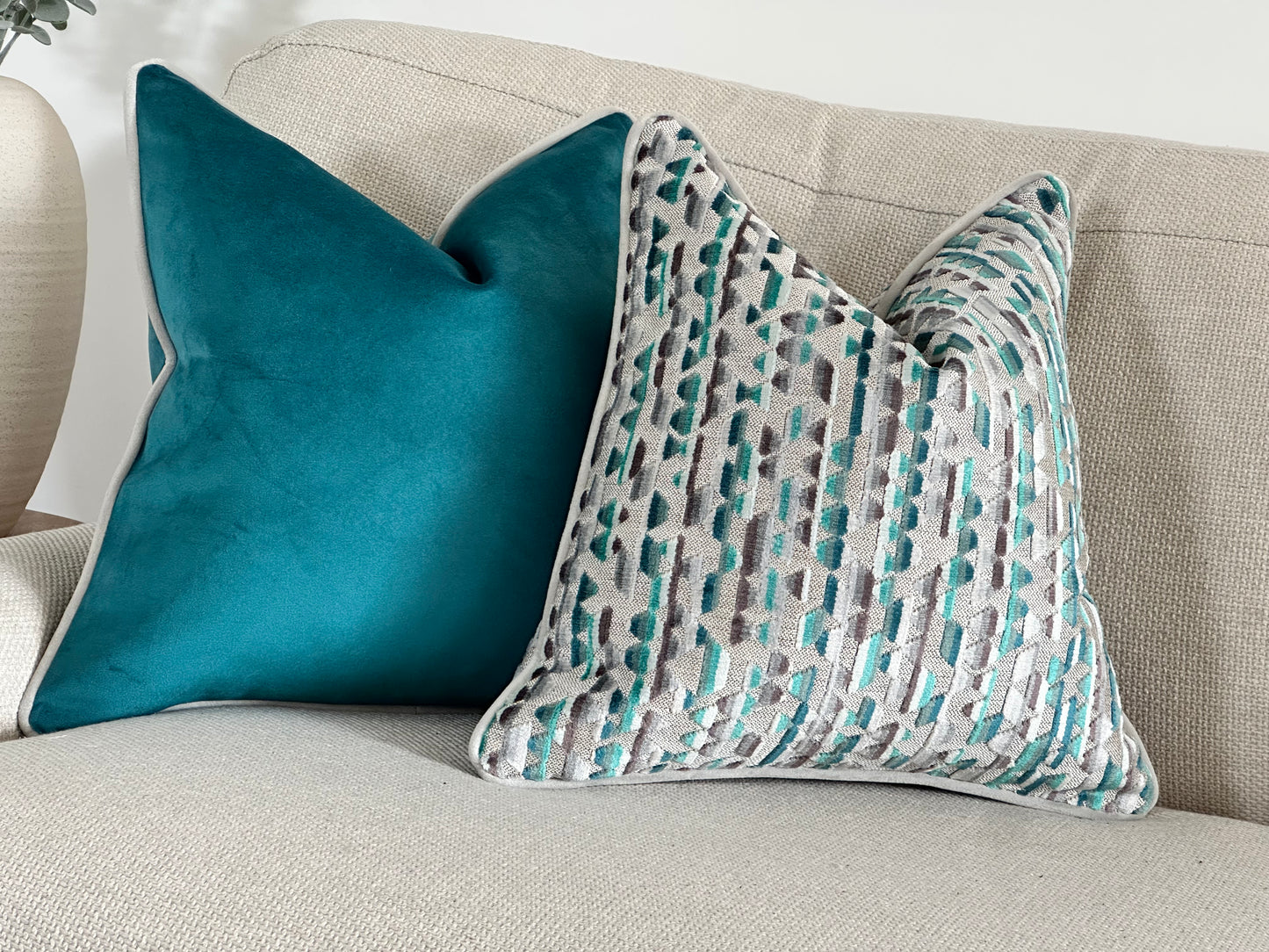 Teal patterned cushion cover.