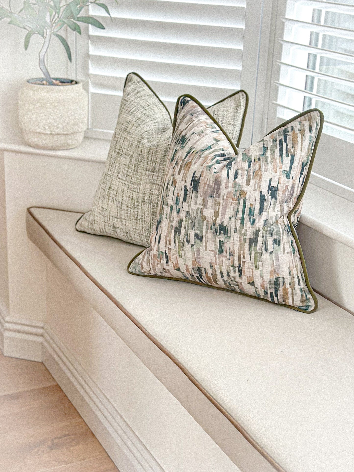 Scatter cushion featuring moss green tones with neat moss green piping.