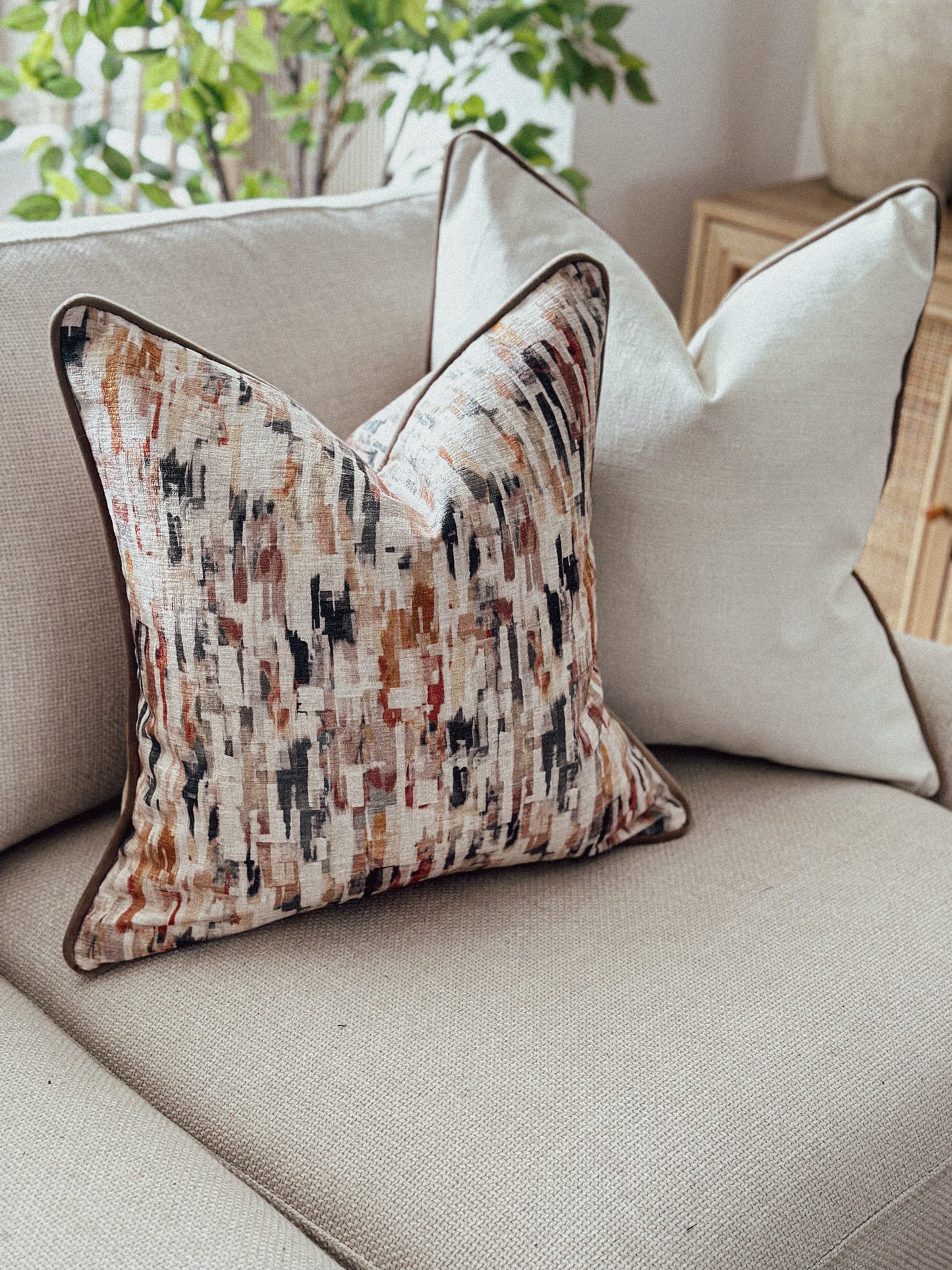 Abstract rust, taupe pillow cover with brown piping — ideal for cosy, layered interiors