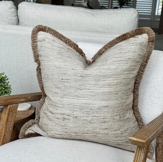 Oatmeal cream, beige cushion with fringing.