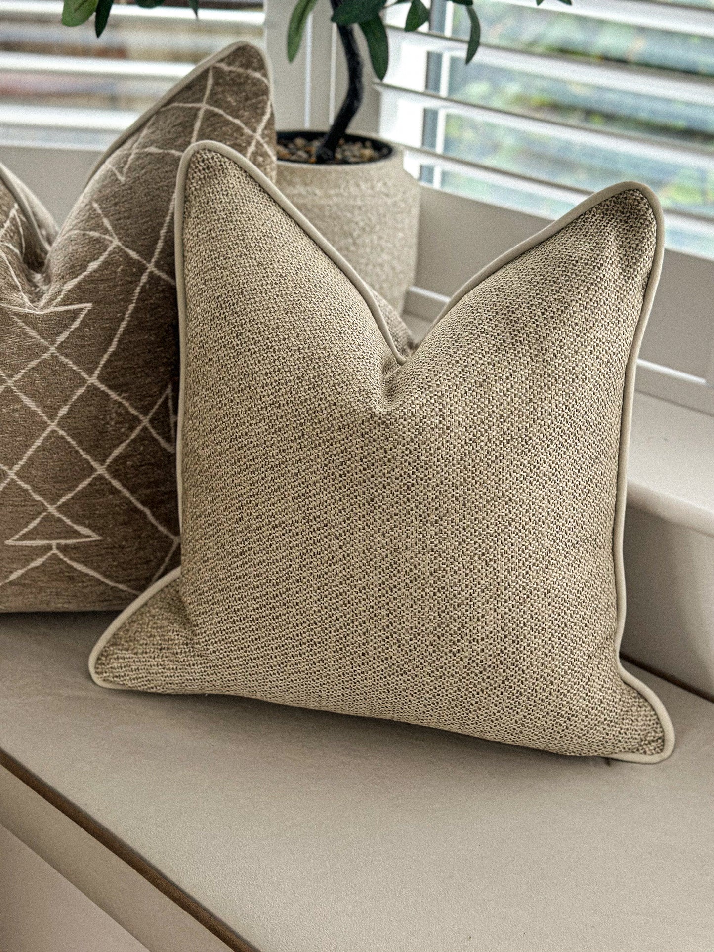 Beige textured scatter cushion.