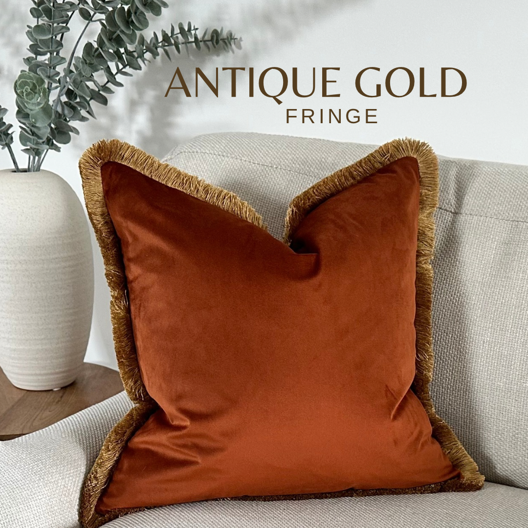 Luxury burnt orange velvet cushion cover with fringe.