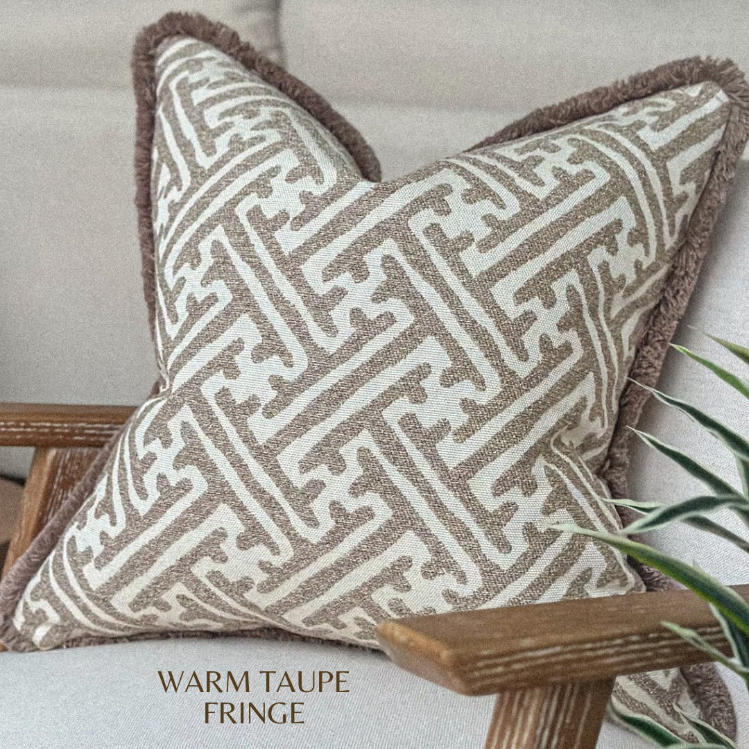 Textured taupe and beige pillow cover with soft mocha trim in a modern living room set