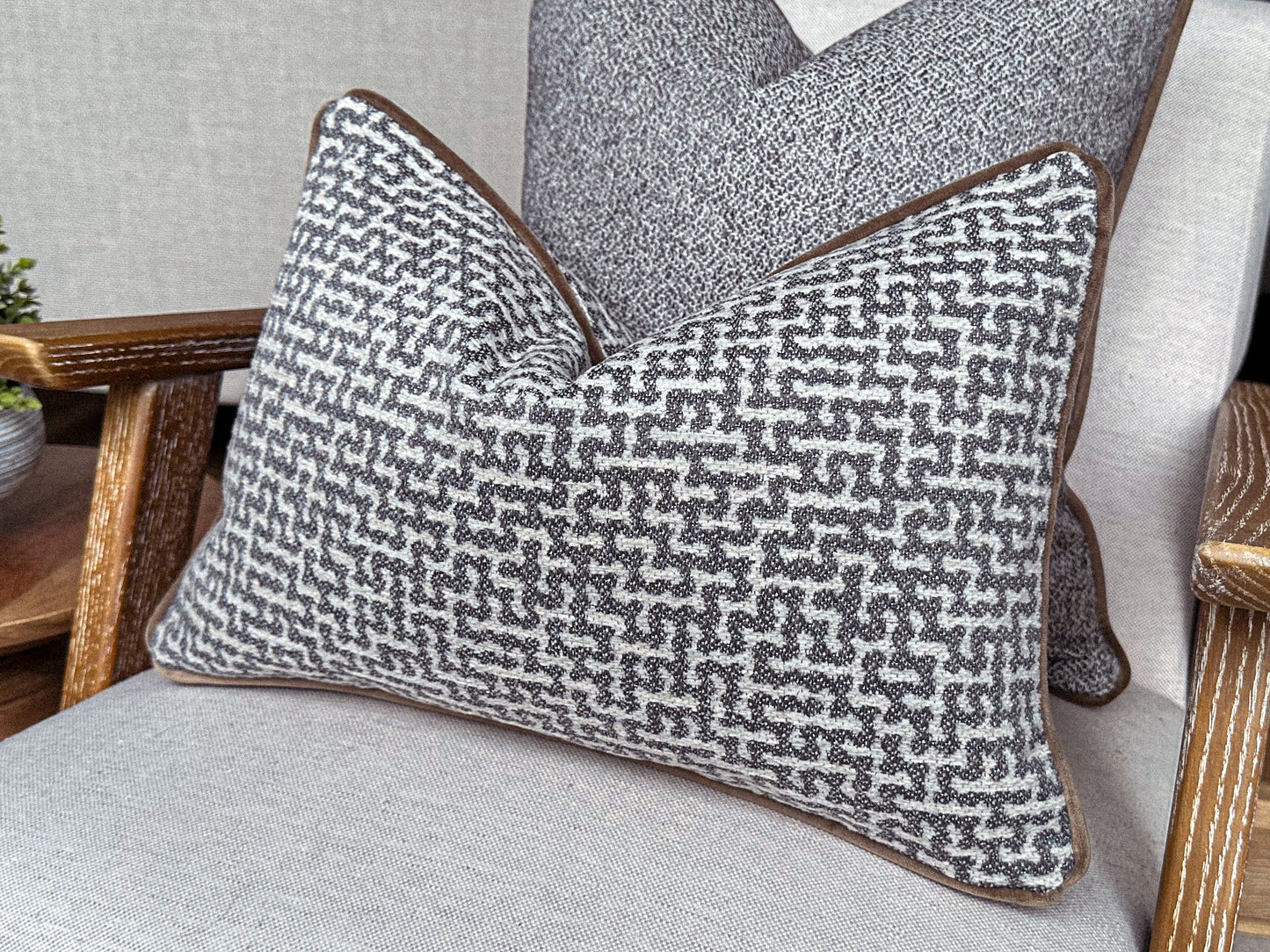 Serene grey blue toned cushion with an ivory woven pattern, calming and elegant decor.