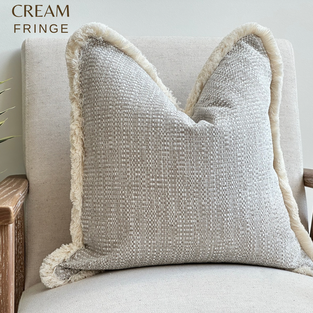 Textured beige cushion with cream fringe