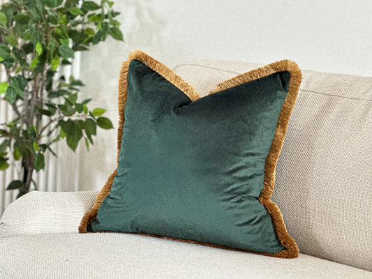 Jade emerald green velvet cushion with customisable antique gold fringe edge.