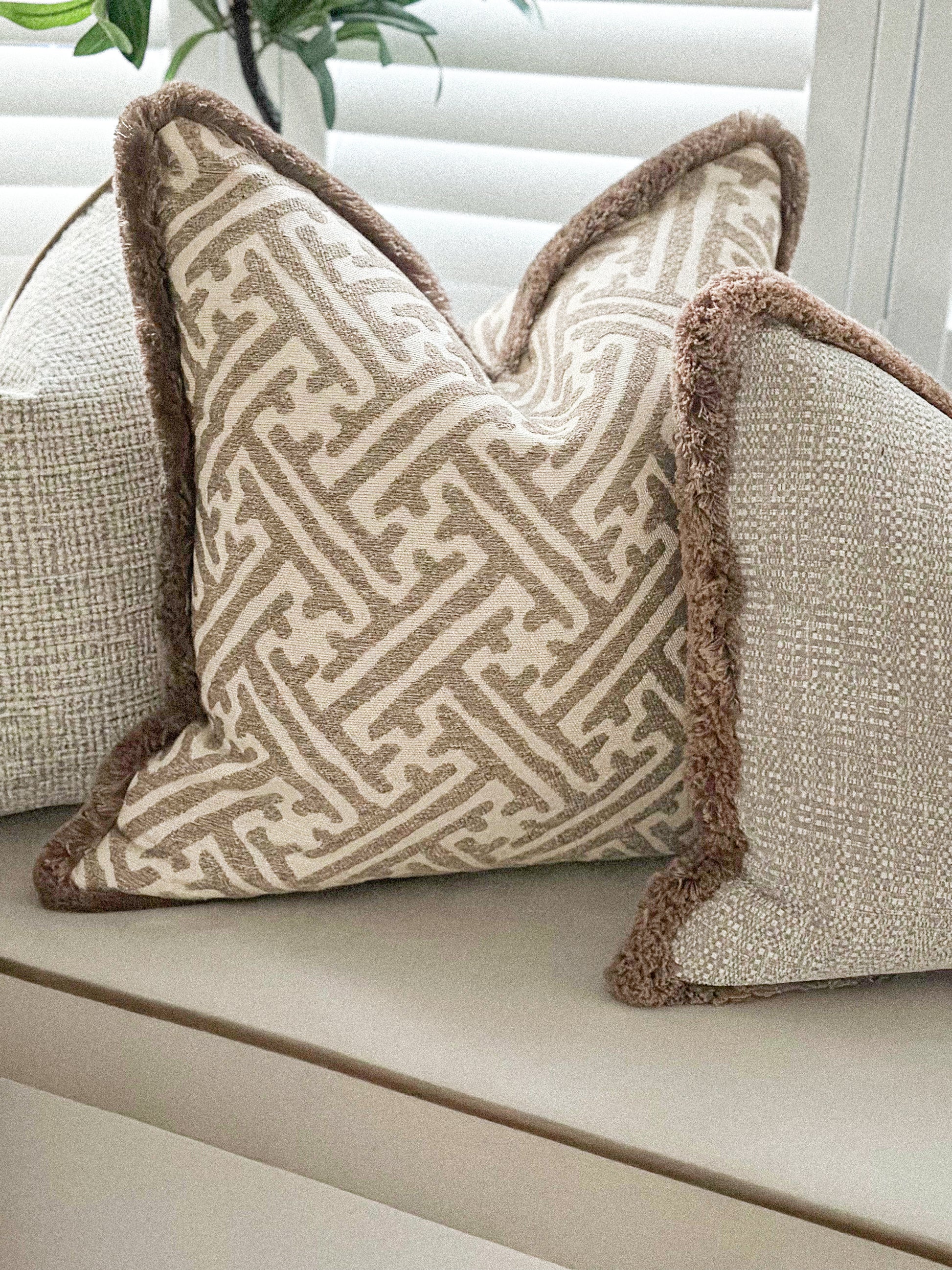 Luxury neutral fringed cushion cover with a beautiful beige design. The best cosy cushions.