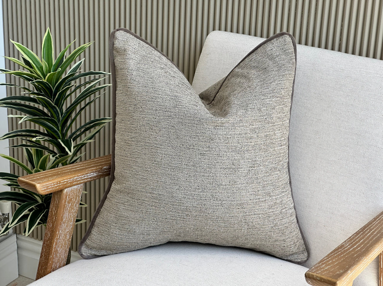 Beige pillow with trim.