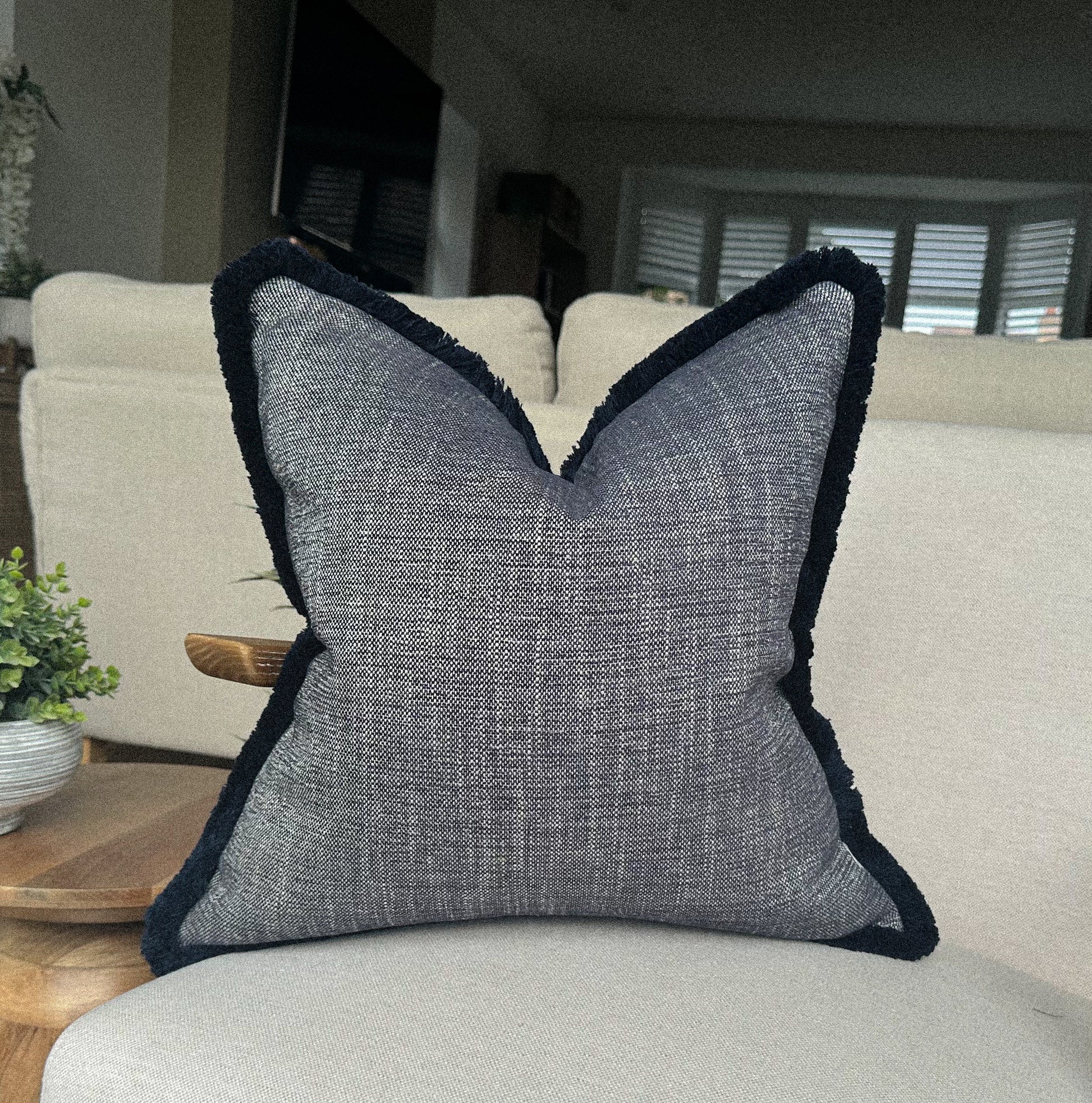Luxury Textured blue cushion with fringe trim.