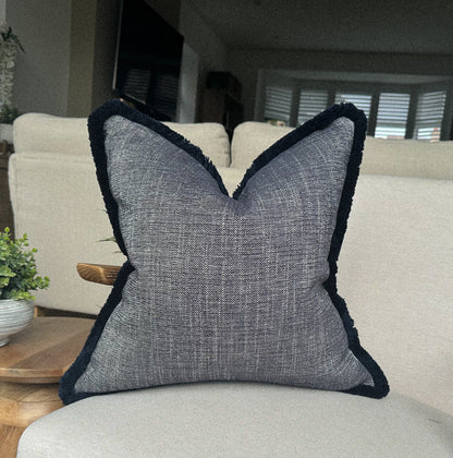 Luxury Textured blue cushion with fringe trim.