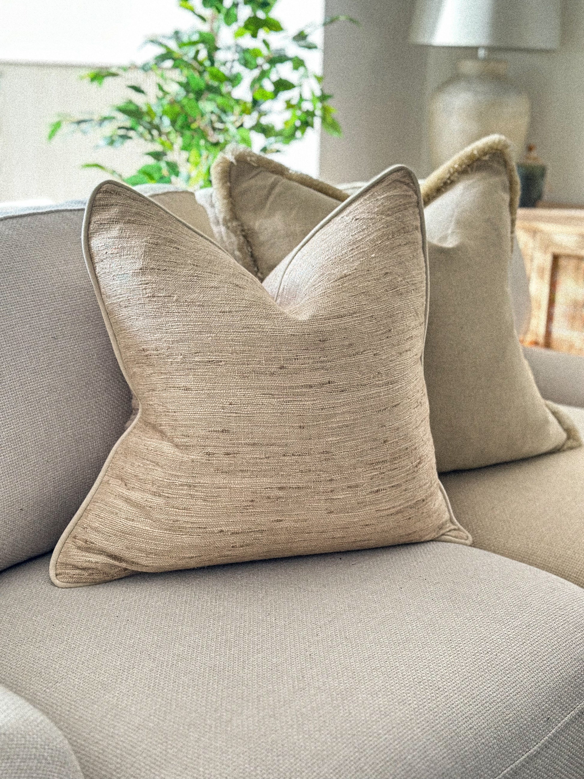 Textured slubby linen cushion in a cream beige oatmeal tone.