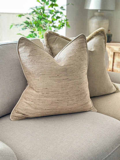 Textured slubby linen cushion in a cream beige oatmeal tone.