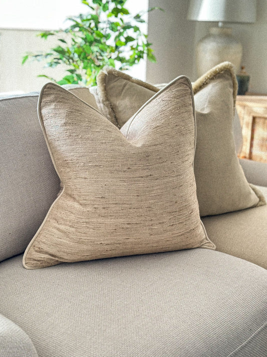 Textured slubby linen cushion in a cream beige oatmeal tone.