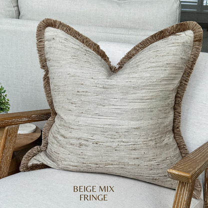 Beige cream textured fringed throw pillow.