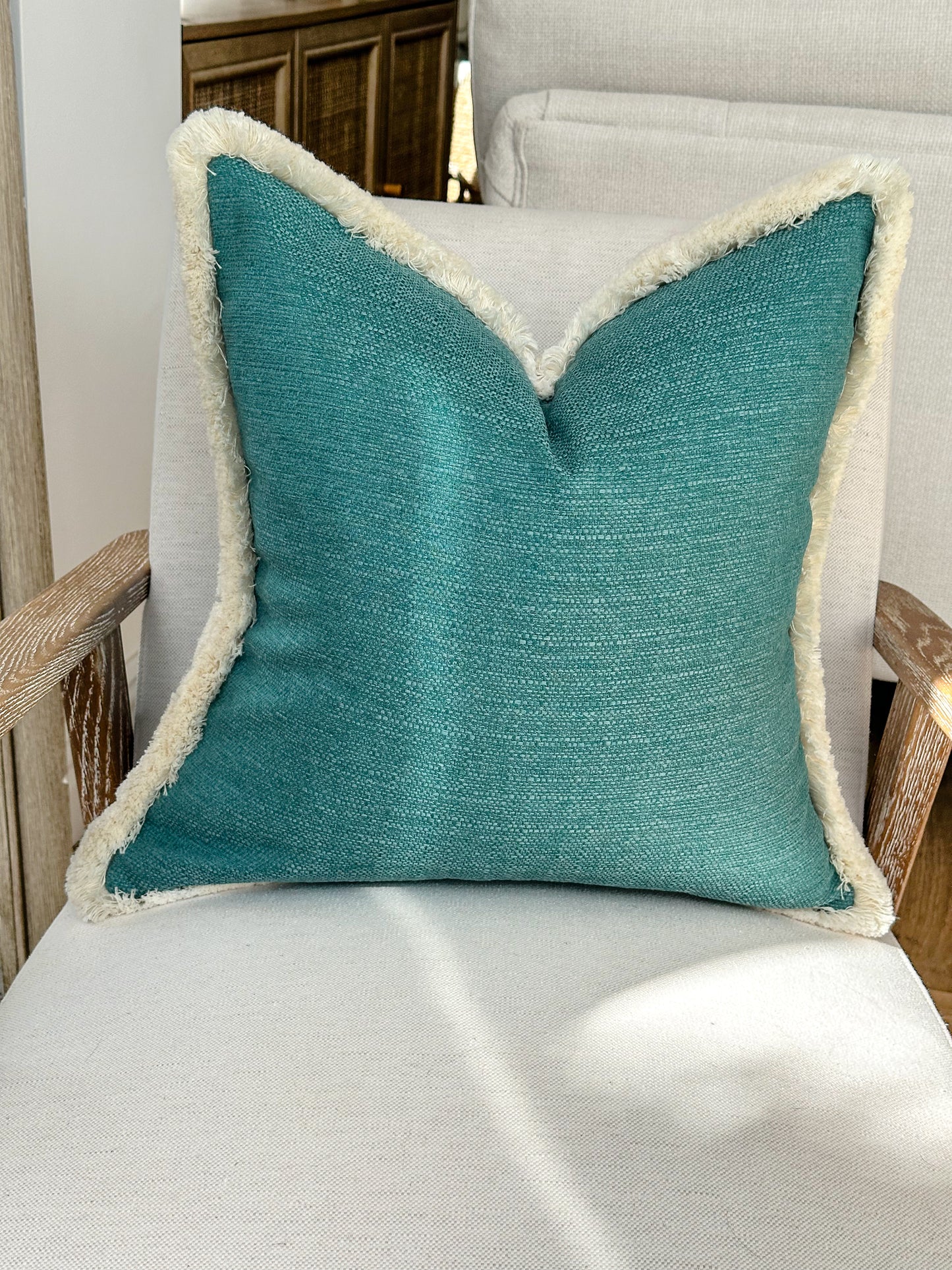 Turquoise Vibrant custom made cushion with fluffy trim.