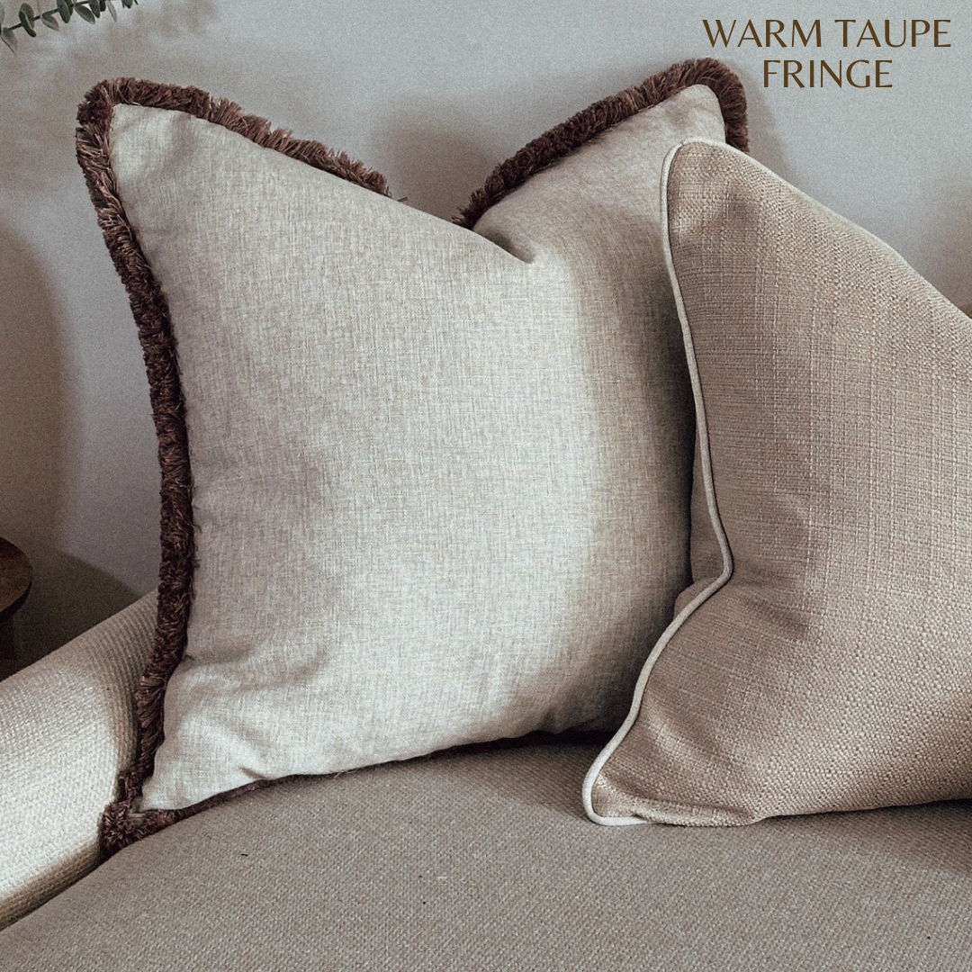 Neutral modern organic throw pillow cover with beige fringing.