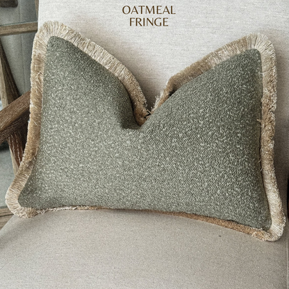 Sage green boucle fringed cushion.