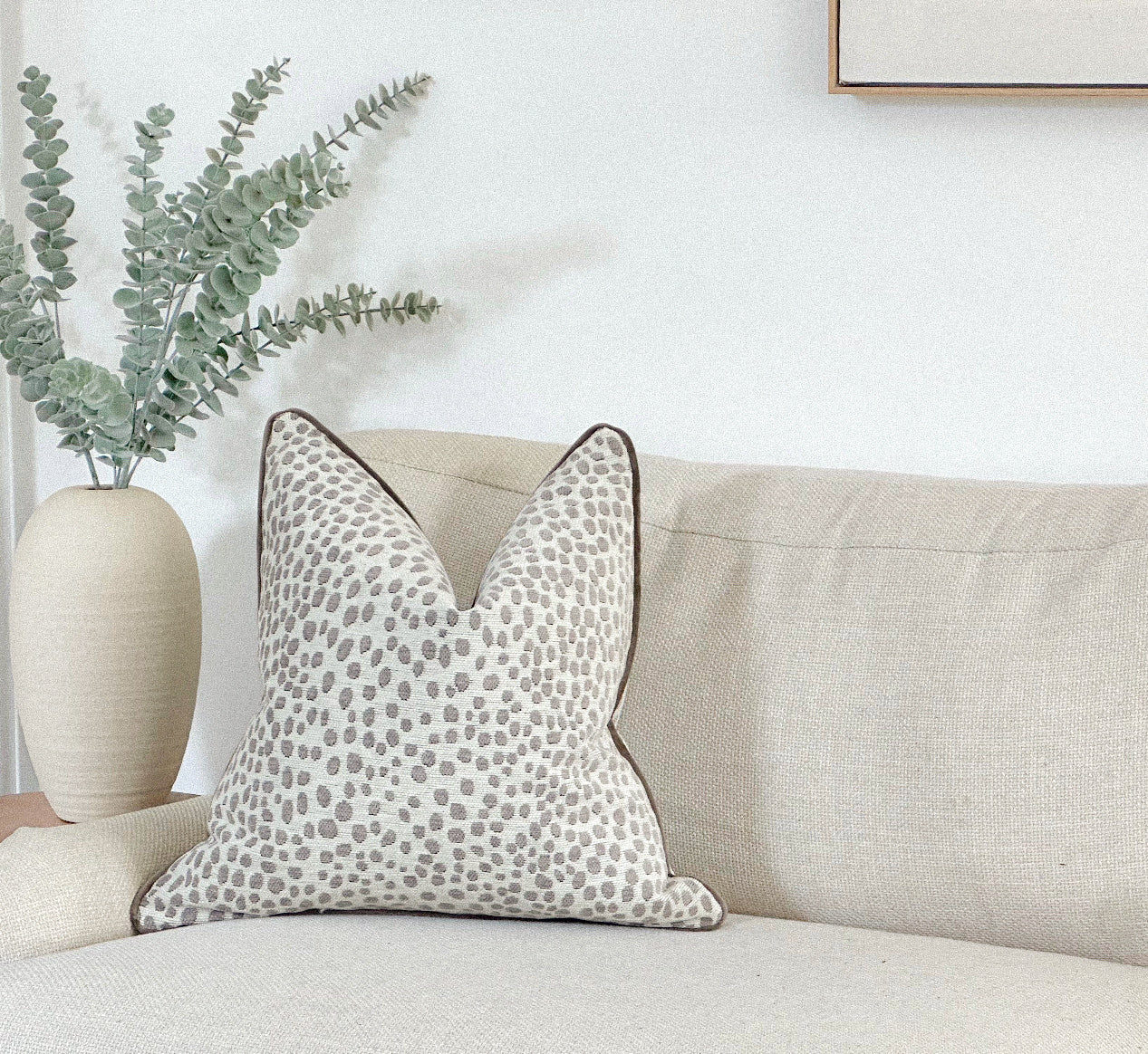 White and grey animal print cushion.