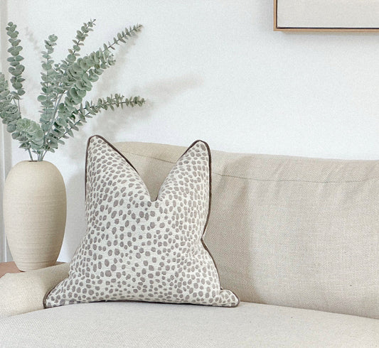 White and grey animal print cushion.