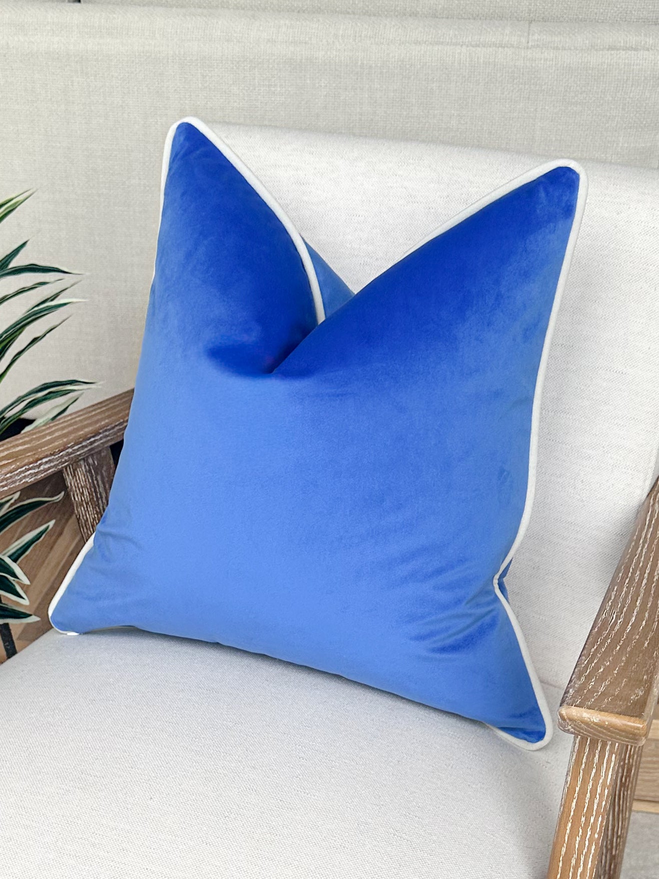 Cobalt blue velvet cushion with customisable ivory white piping. 