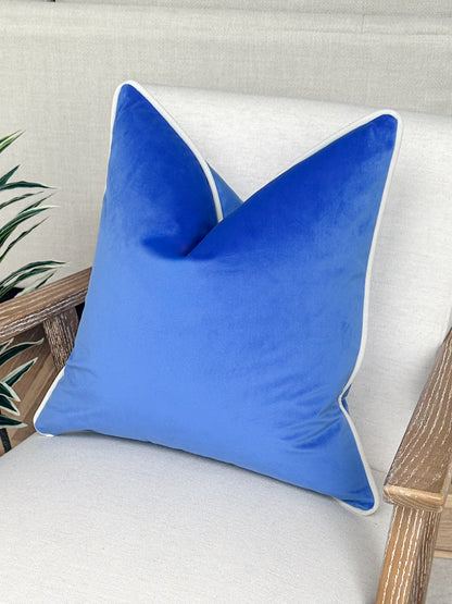 Cobalt blue velvet cushion with customisable ivory white piping. 