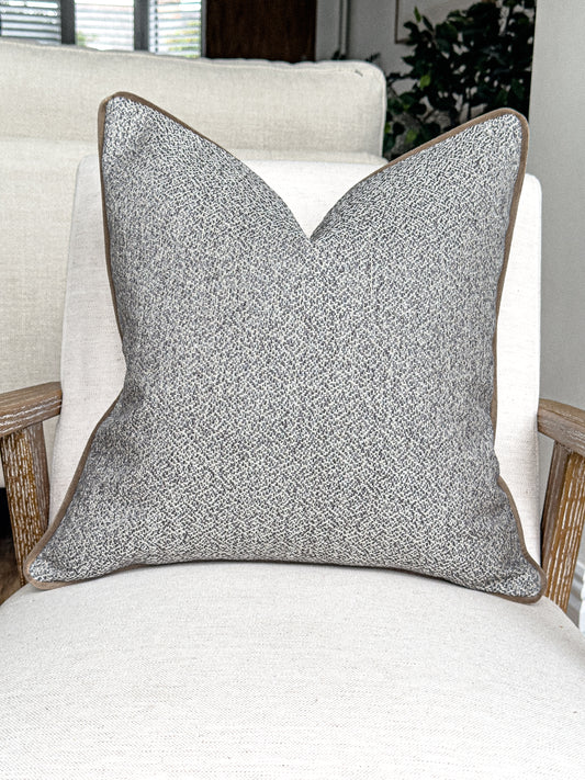 Costal grey cushion with subtly ivory textured with a piping trim.