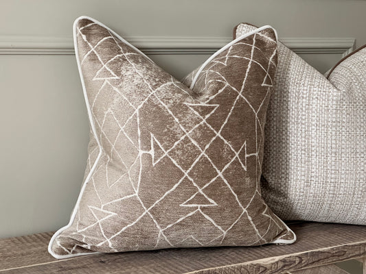 Taupe geometric cushion cover.