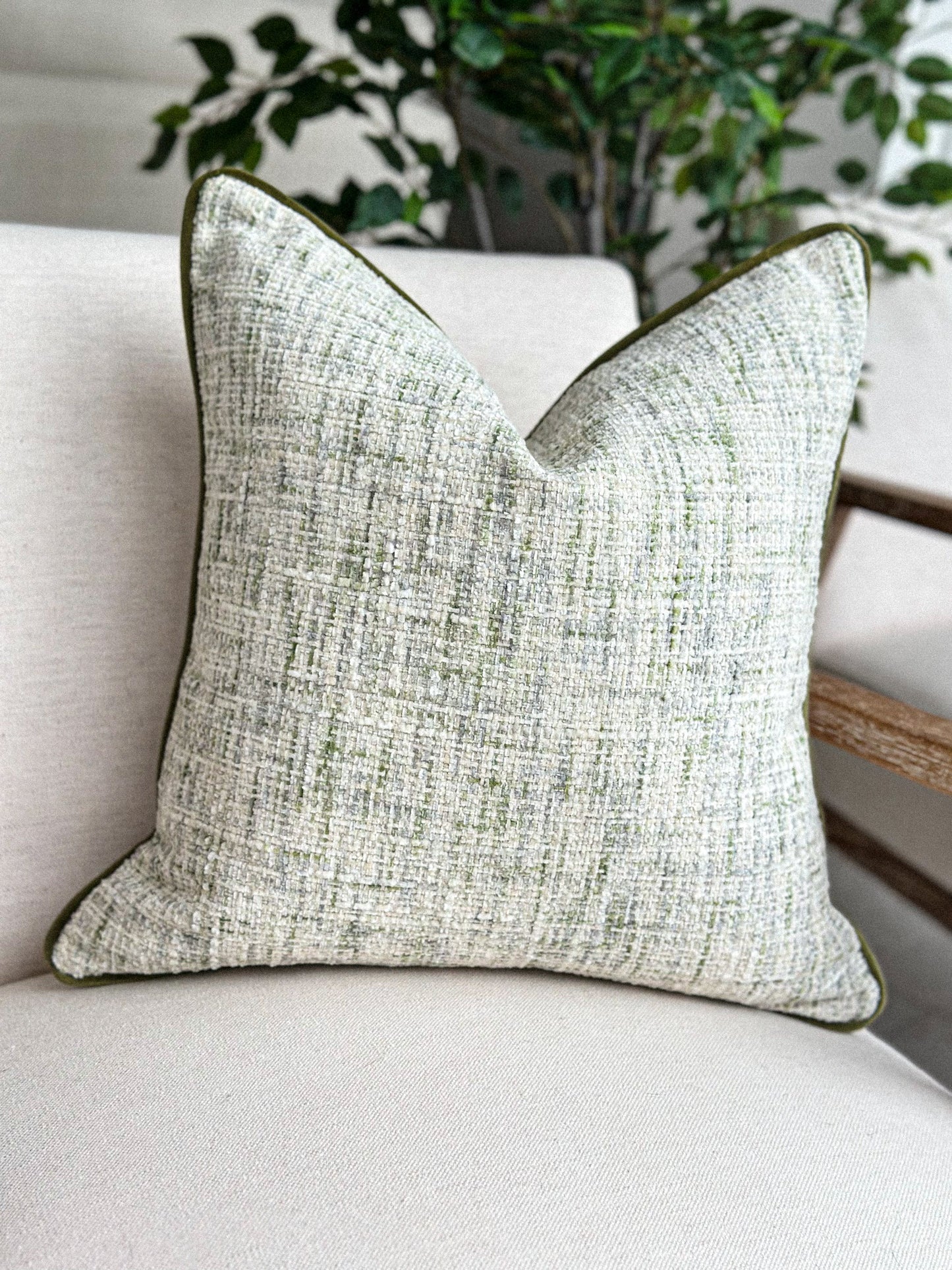 Textured scatter cushion in soft stone and muted green for a calm, natural interior.