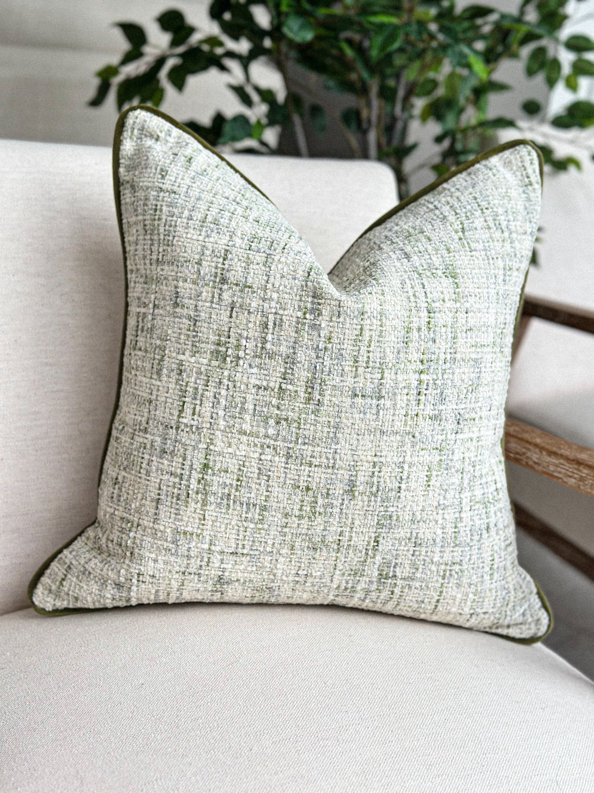 Textured scatter cushion in soft stone and muted green for a calm, natural interior.