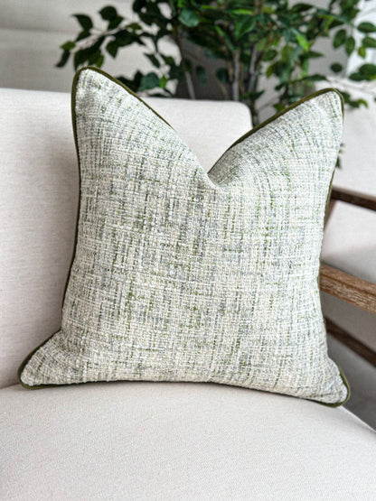 Textured scatter cushion in soft stone and muted green for a calm, natural interior.