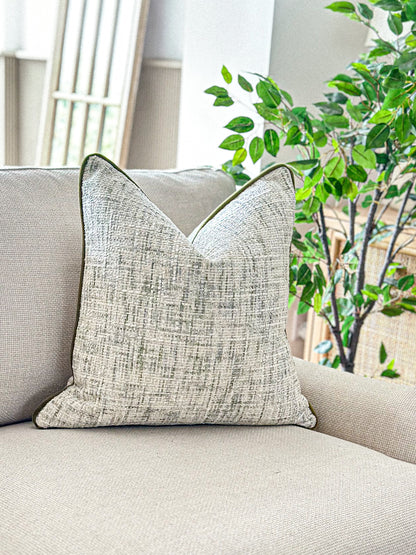 Cosy textured weave pillow with hints of green prefect for modern organic earthy decor.