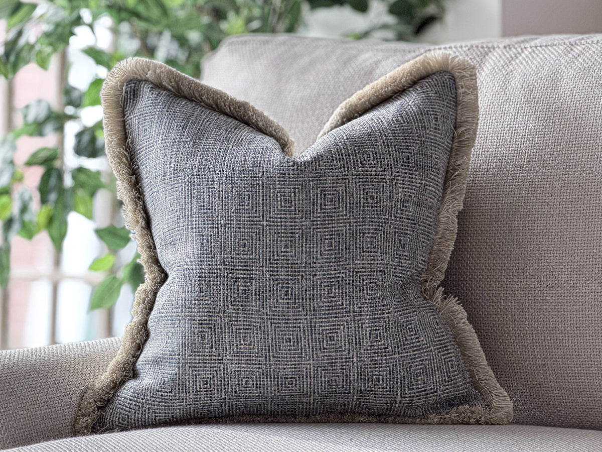 Blue geometric cushion with fringing