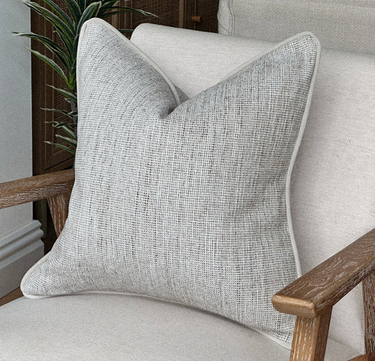 Texture neutral ivory cushion cover.