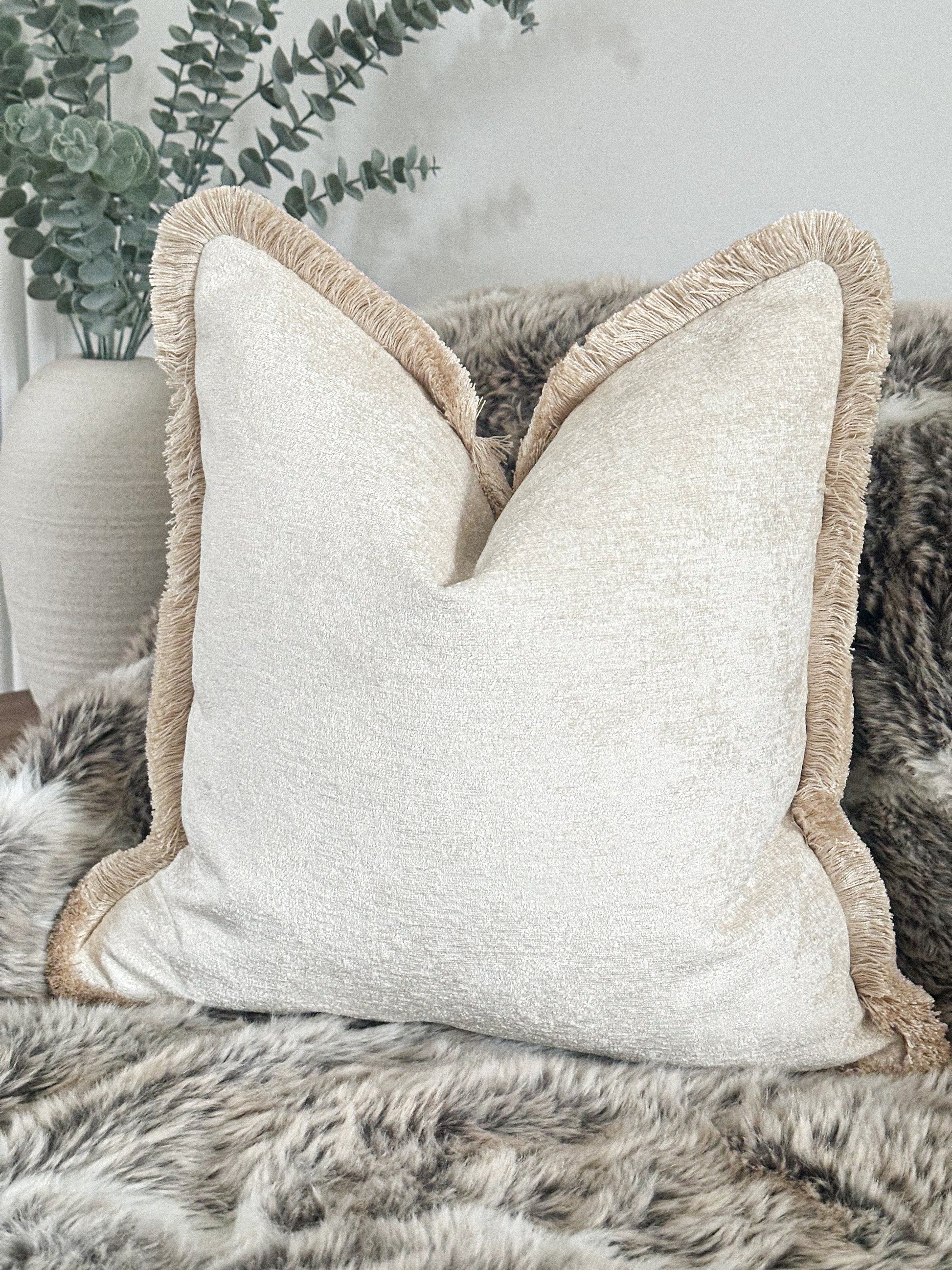 Luxury off white textured cushion with fringe.
