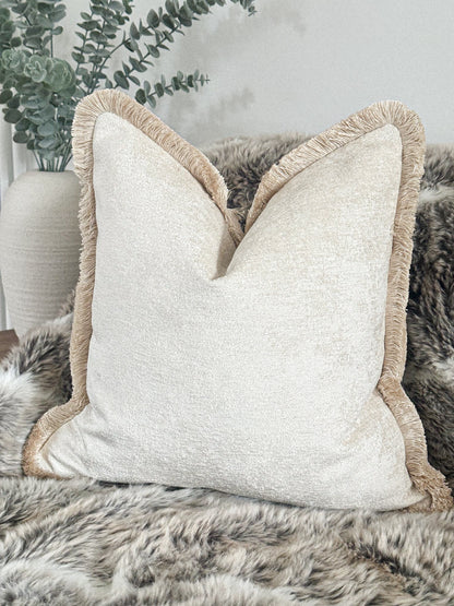 Luxury off white textured cushion with fringe.