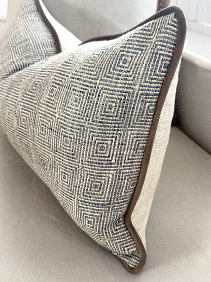 Close up of a blue patterned rectangle cushion.