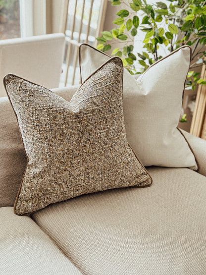 Warm caramel and taupe textured cushion with brown piping — perfect for cosy autumn decor