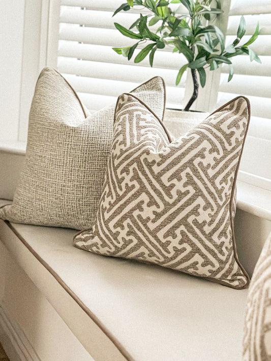 Luxury beige and cream cushion with geometric design.