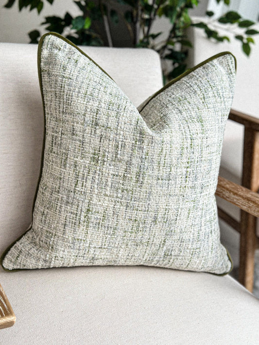 Textured sage green and cream woven cushion, perfect for neutral, earthy interiors.