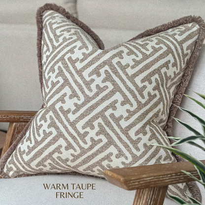 Textured taupe and beige pillow cover with soft mocha trim in a modern living room set