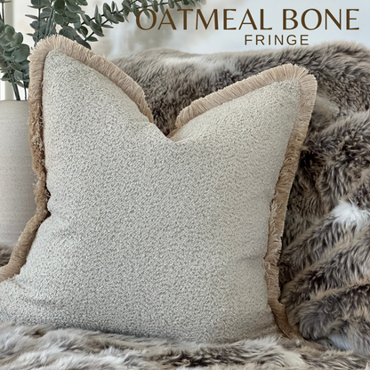 Luxury cream boucle cushion cover with fringe.
