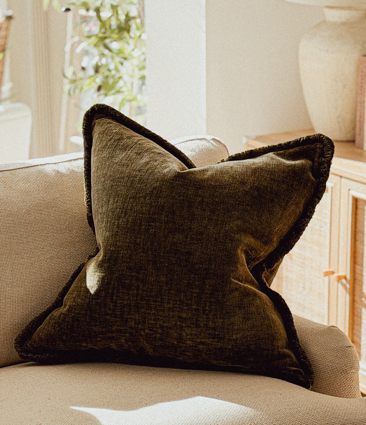 Earthy dark green velvet textured cushion.
