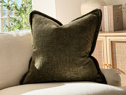 A Luxury earthy green textured scatter cushion with fringe trim.