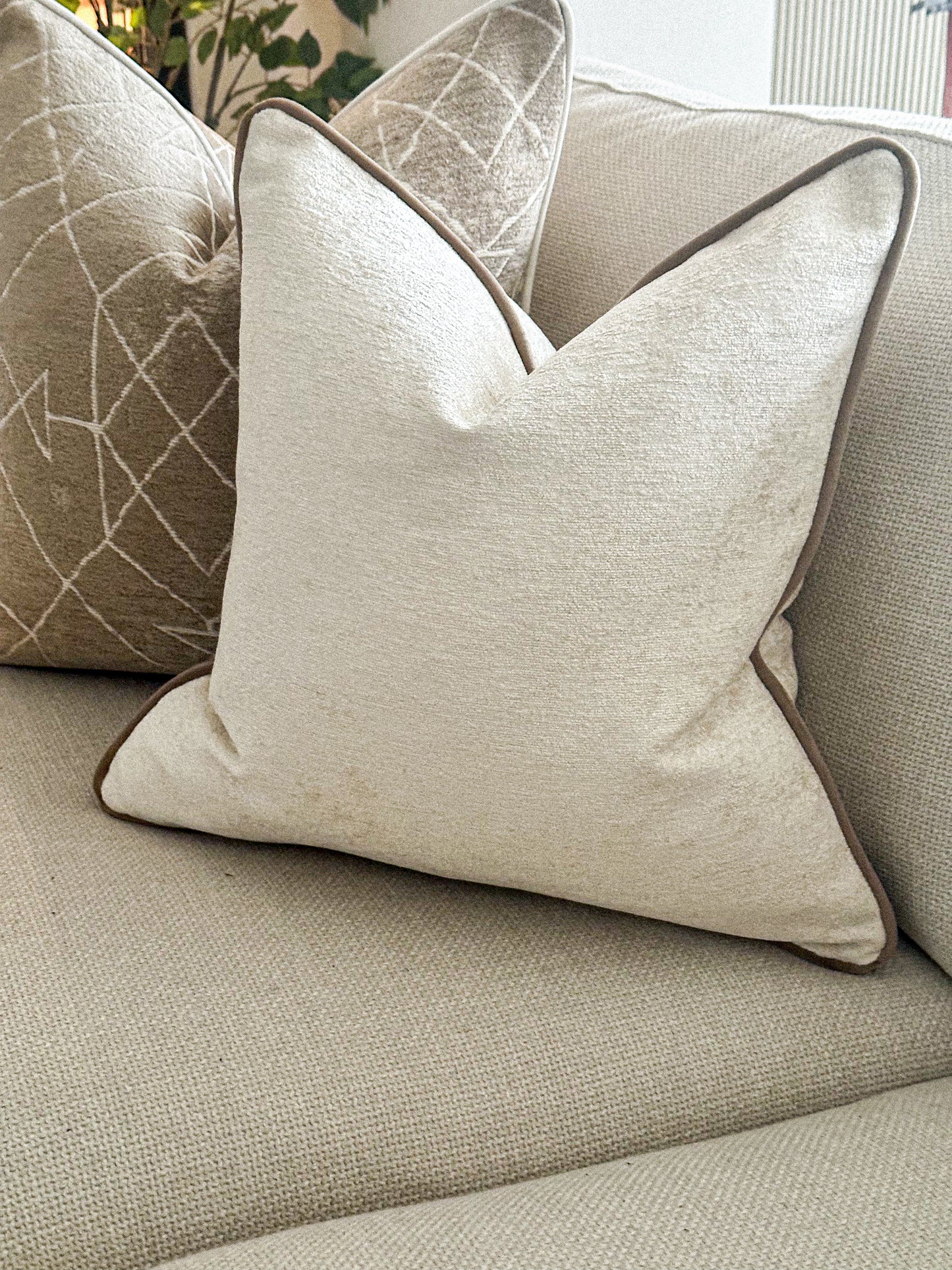 Luxury Ivory textured pillow with beige trim.