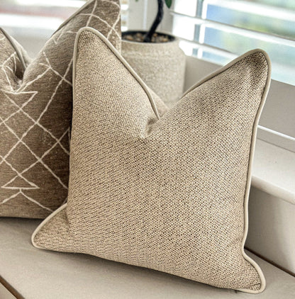 Textured beige cushion with soft neutral weave — perfect for earthy, natural home déCor