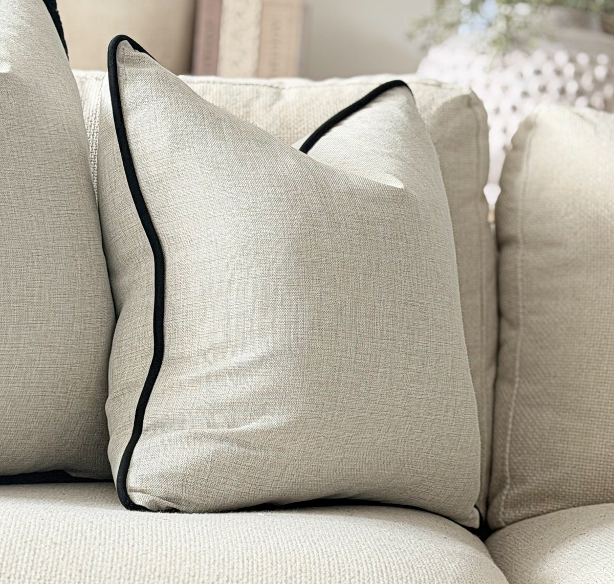 Luxury modern organ Greige pillow with customisable black trim.