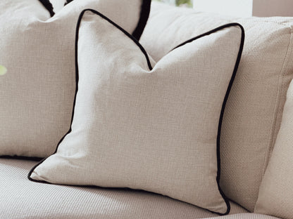 Natural cushions with a black piping trim.