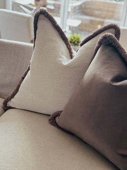 Neutral beige textured cushion with warm taupe fringe trim — perfect for cosy, earthy home décor.